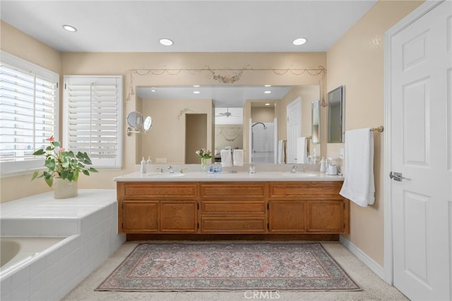 bathroom featuring recessed lighting, walk in shower, a sink, and double vanity