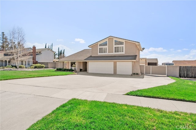 view of front of property with stucco siding, a front yard, fence, a garage, and driveway