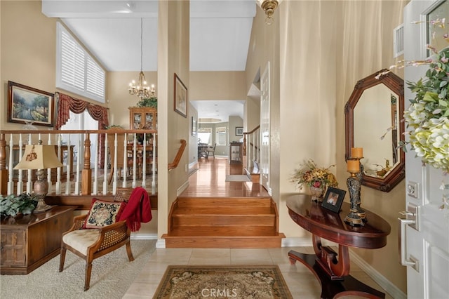 interior space featuring light tile patterned floors, stairway, a chandelier, and a healthy amount of sunlight