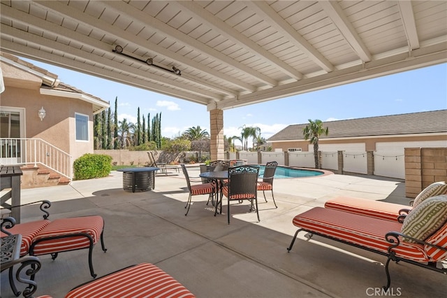 view of patio with a fenced in pool, outdoor dining space, and a fenced backyard