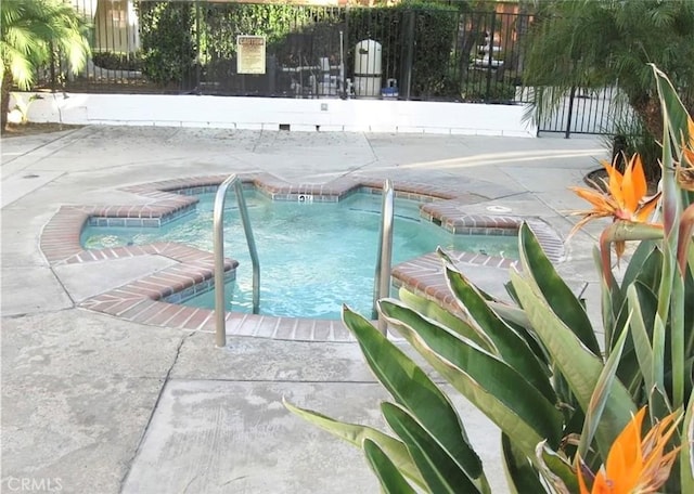 view of pool with a patio area, fence, and a pool