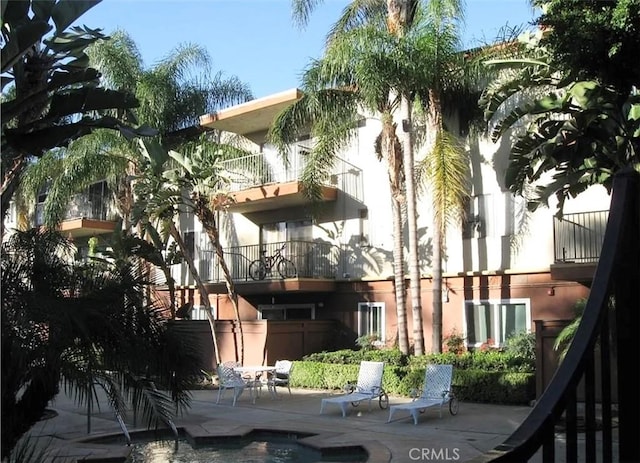 view of building exterior with an outdoor pool