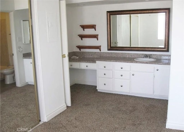 bathroom with toilet, carpet floors, and vanity