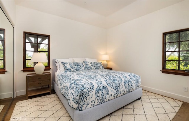 bedroom featuring light wood-type flooring and baseboards