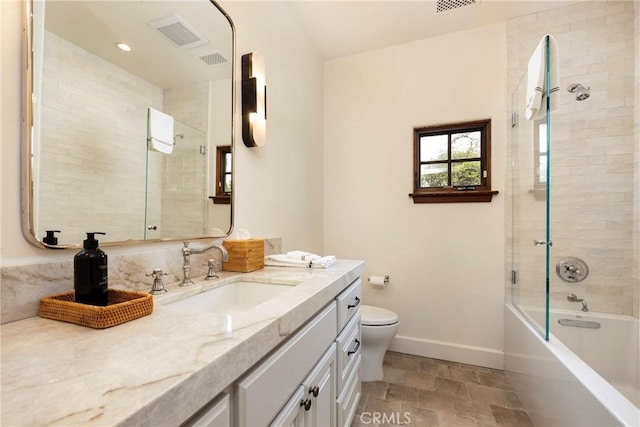 bathroom with visible vents, baseboards, toilet, stone finish floor, and vanity