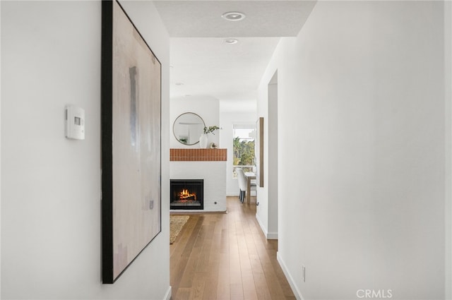 hallway with hardwood / wood-style flooring and baseboards