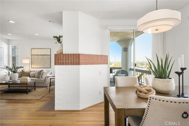 dining room featuring a textured ceiling, wood finished floors, and recessed lighting