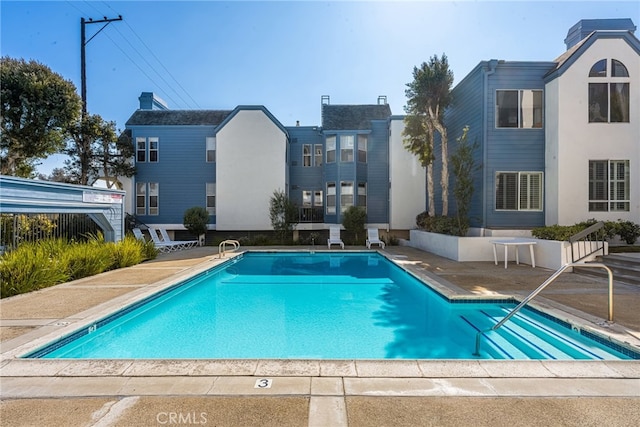 community pool featuring a patio area