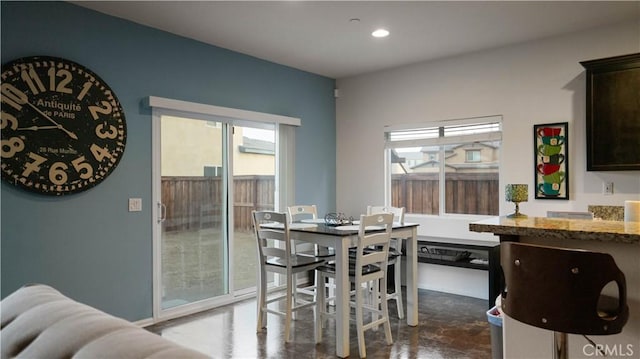 dining space featuring recessed lighting and plenty of natural light