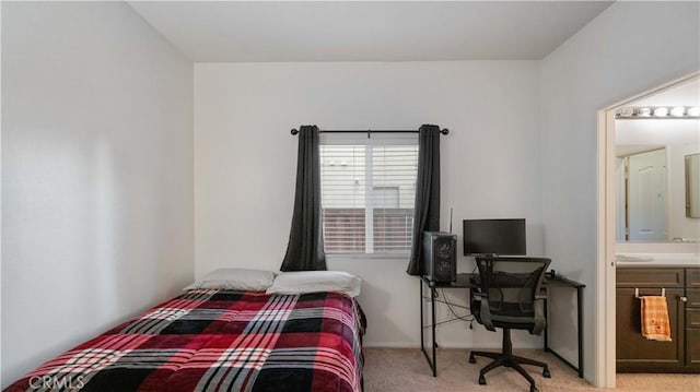 bedroom with light carpet and ensuite bathroom