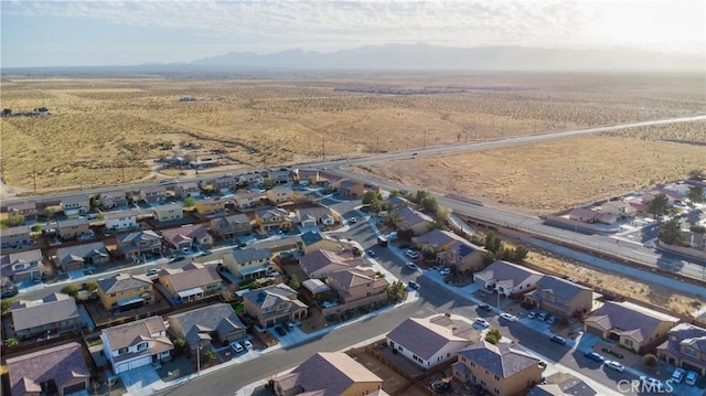 bird's eye view featuring a residential view, a mountain view, and view of desert