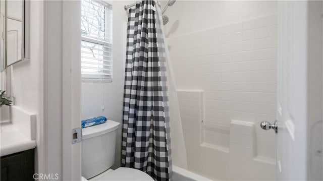 bathroom featuring vanity, shower / bath combo with shower curtain, and toilet