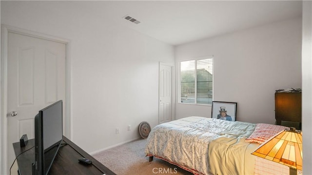 carpeted bedroom with visible vents and baseboards