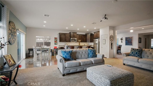 living room with visible vents, light colored carpet, and recessed lighting