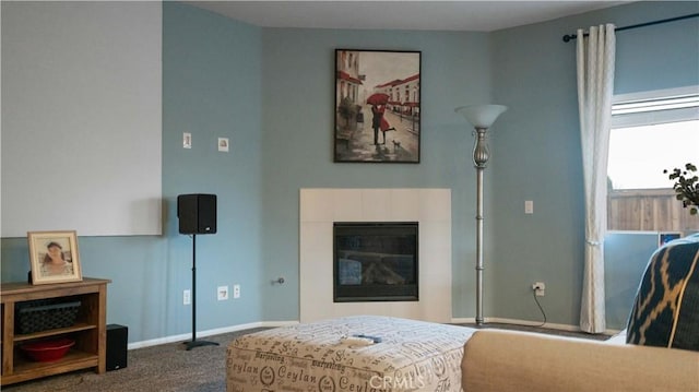 living area with carpet flooring, a fireplace, and baseboards