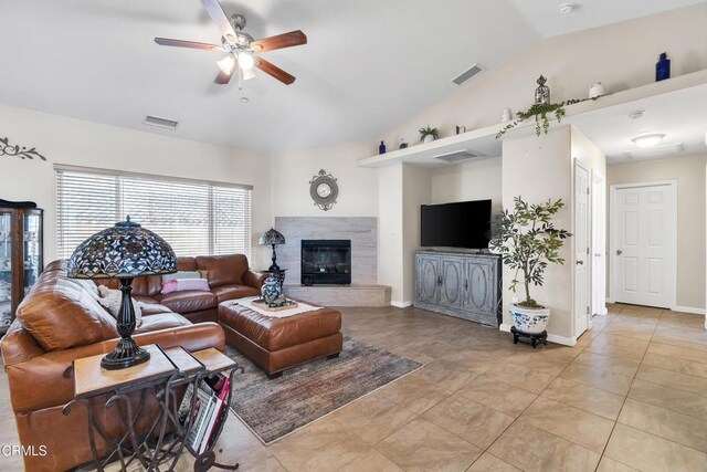 17717 Bangor Ave, Hesperia, CA 92345 - living area featuring lofted ceiling, ceiling fan, a tiled fireplace, and light tile patterned floors