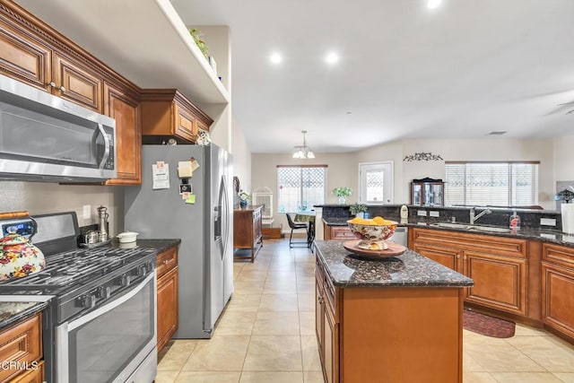17717 Bangor Ave, Hesperia, CA 92345 - kitchen featuring stainless steel appliances, a sink, light tile patterned flooring, a kitchen island, and dark stone countertops