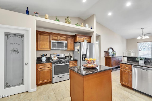 17717 Bangor Ave, Hesperia, CA 92345 - kitchen featuring appliances with stainless steel finishes, lofted ceiling, a center island, brown cabinets, and dark stone countertops