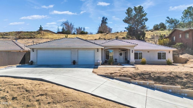 17717 Bangor Ave, Hesperia, CA 92345 - ranch-style house featuring a garage, concrete driveway, stucco siding, and a tiled roof