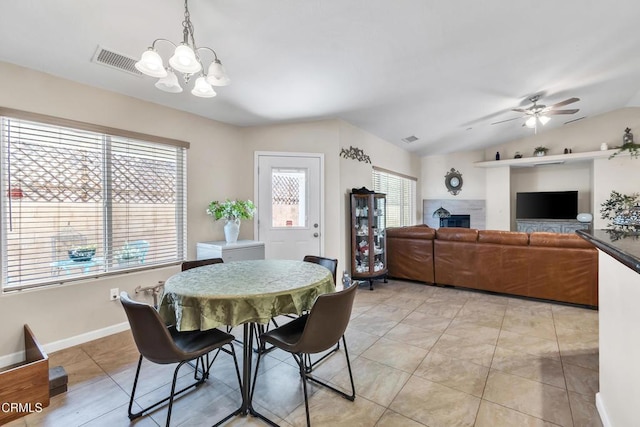 17717 Bangor Ave, Hesperia, CA 92345 - dining area with a chandelier, a fireplace, a ceiling fan, light tile patterned flooring, and vaulted ceiling