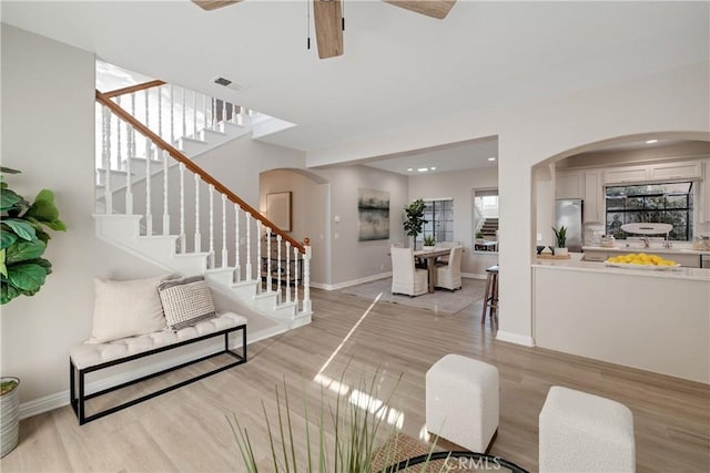 foyer entrance featuring light wood-style floors, stairs, and visible vents