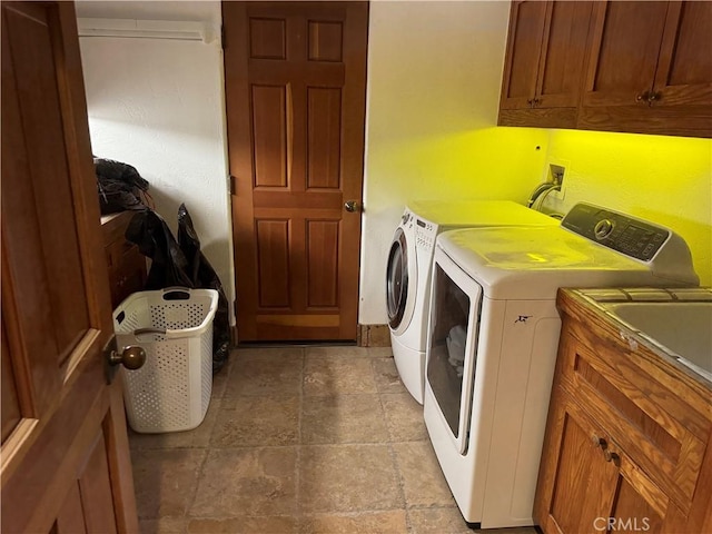 30532 Marbella, San Juan Capistrano, CA 92675 - laundry area with washing machine and clothes dryer, cabinet space, and light stone finish flooring