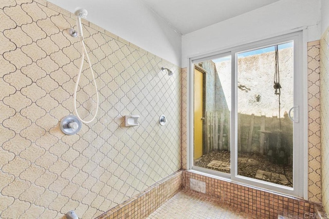 bathroom with a tile shower