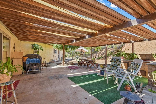 view of patio with outdoor dining space, area for grilling, and a pergola