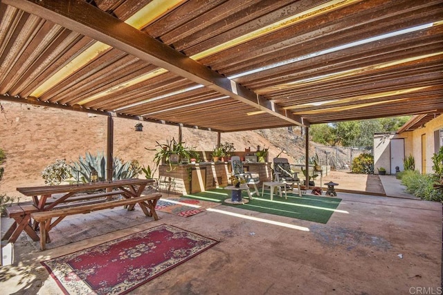 view of patio featuring a shed and an outdoor structure