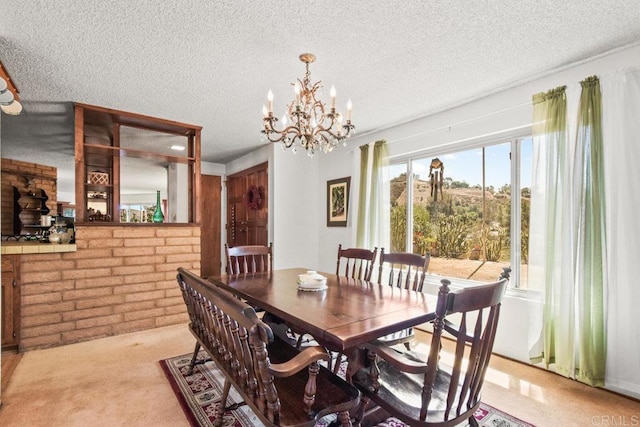 dining area with light colored carpet, a textured ceiling, brick wall, and an inviting chandelier