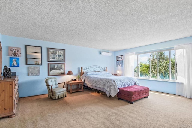 bedroom with a textured ceiling, carpet floors, and an AC wall unit