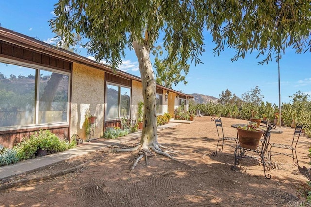 view of yard featuring a patio area and a mountain view