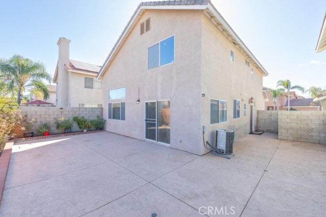 929 Pinecone Dr, Corona, CA 92878 - rear view of property featuring a patio, cooling unit, a fenced backyard, and stucco siding