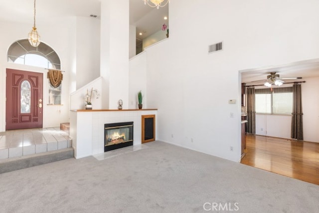 929 Pinecone Dr, Corona, CA 92878 - unfurnished living room with ceiling fan, carpet, visible vents, and a tile fireplace