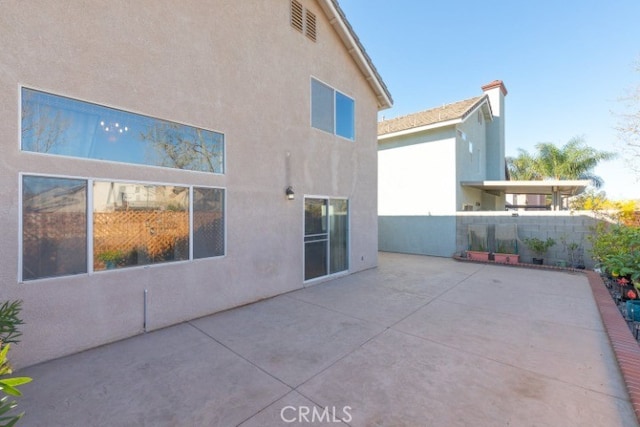 929 Pinecone Dr, Corona, CA 92878 - back of house with a patio area, fence, and stucco siding