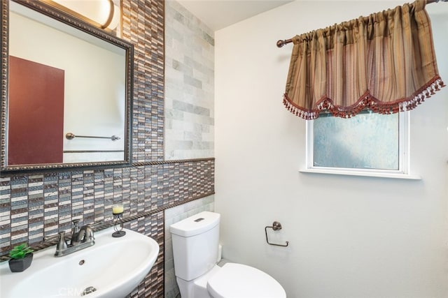 929 Pinecone Dr, Corona, CA 92878 - half bath featuring decorative backsplash, toilet, tile walls, and a sink