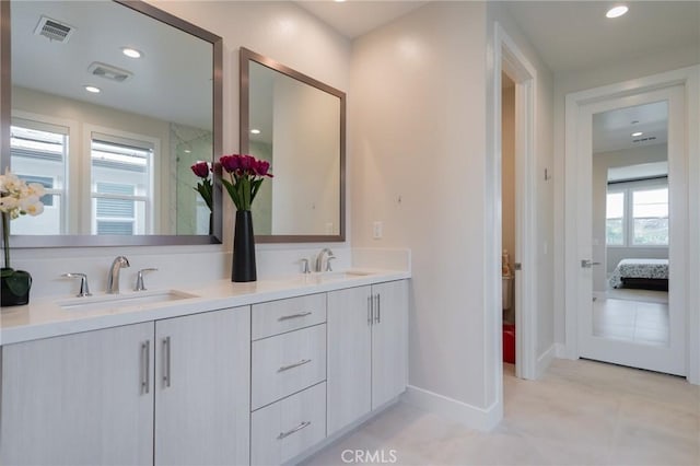 full bath featuring recessed lighting, visible vents, a sink, and double vanity