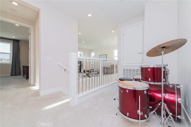 hallway featuring recessed lighting, baseboards, carpet flooring, and an upstairs landing