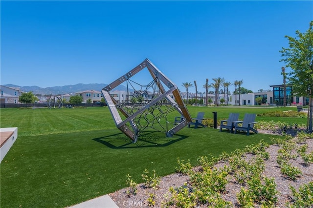 view of play area featuring a yard and a mountain view