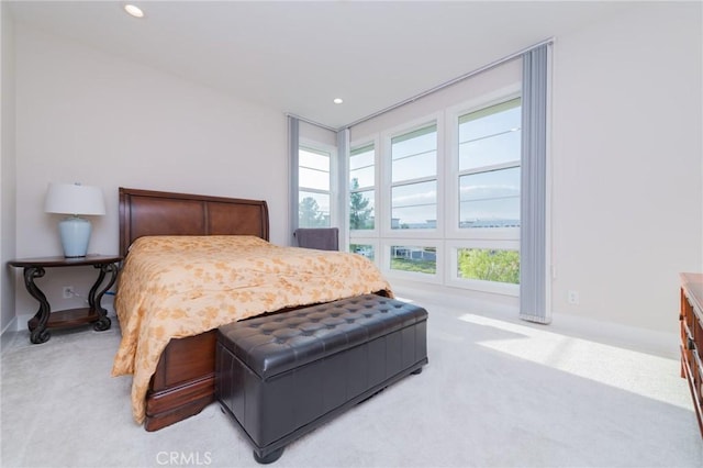 bedroom with baseboards, recessed lighting, and light colored carpet