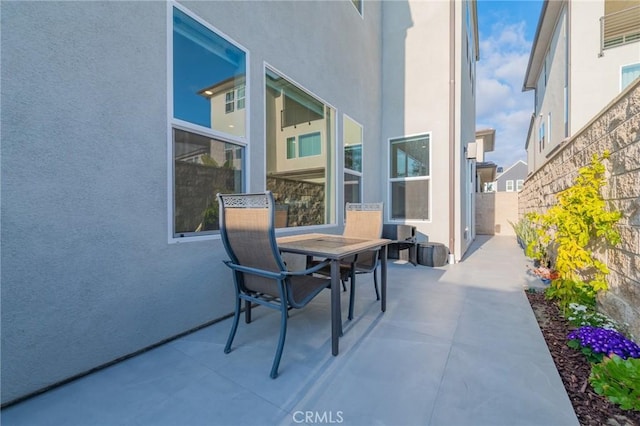 view of patio featuring fence and outdoor dining area