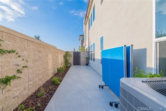 view of patio with a fenced backyard and central AC unit