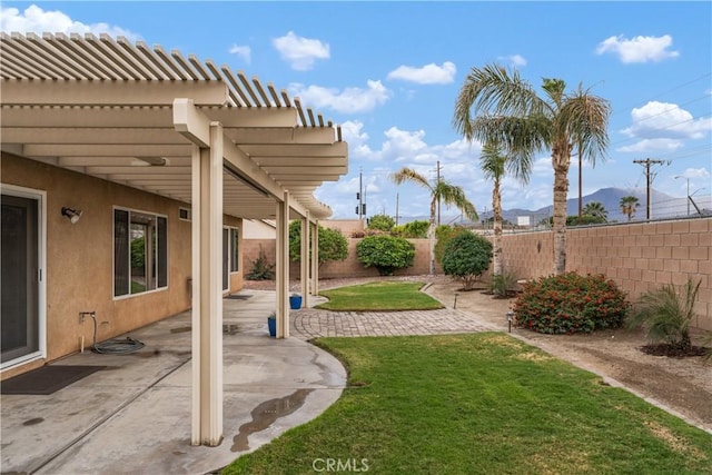 view of yard with a patio area, a pergola, and a fenced backyard