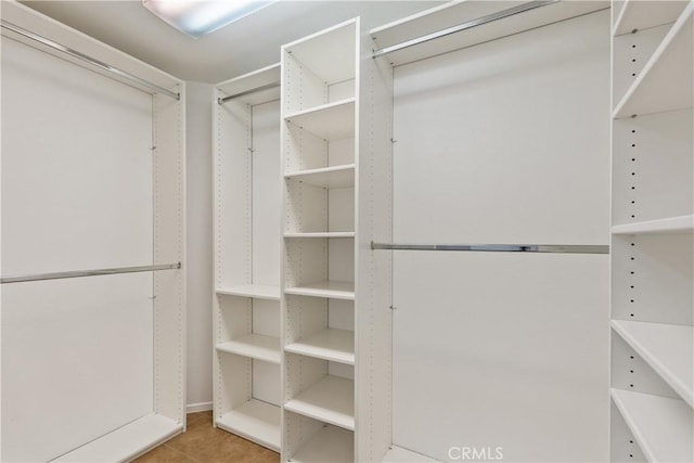 walk in closet with tile patterned floors