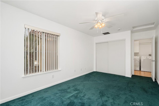 unfurnished bedroom with visible vents, a closet, carpet flooring, baseboards, and washing machine and clothes dryer