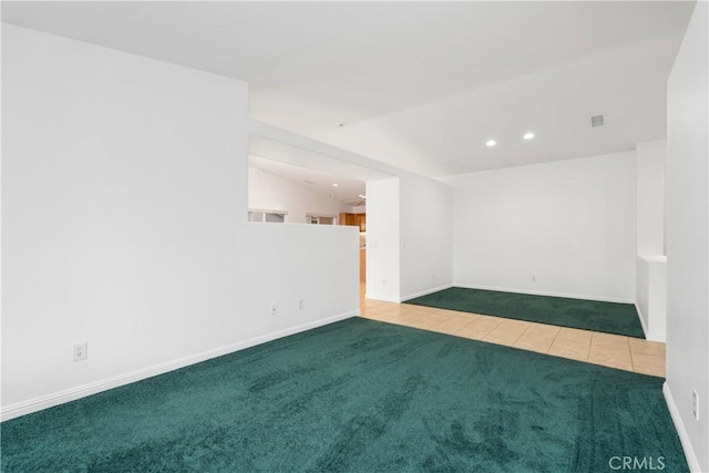 tiled spare room featuring lofted ceiling, carpet flooring, recessed lighting, and baseboards