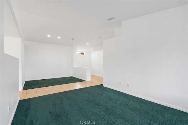 carpeted empty room with tile patterned flooring, recessed lighting, visible vents, and baseboards