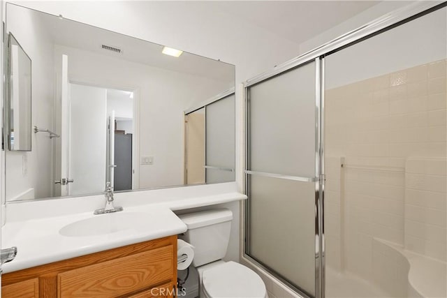 bathroom with visible vents, toilet, an enclosed shower, and vanity