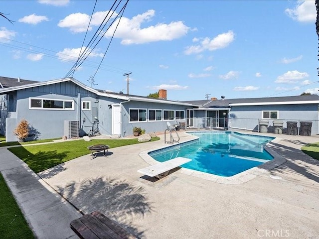view of pool featuring central AC unit, a fire pit, a fenced in pool, fence, and a patio area
