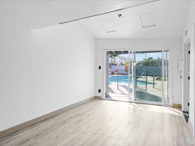 unfurnished room with wood finished floors and baseboards